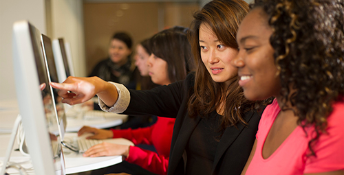 Students talking at computer