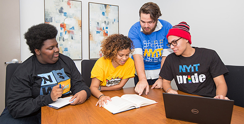 three students looking at laptop together