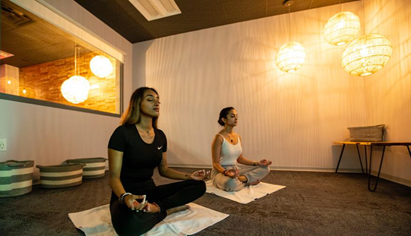 Students meditating on the floor of room