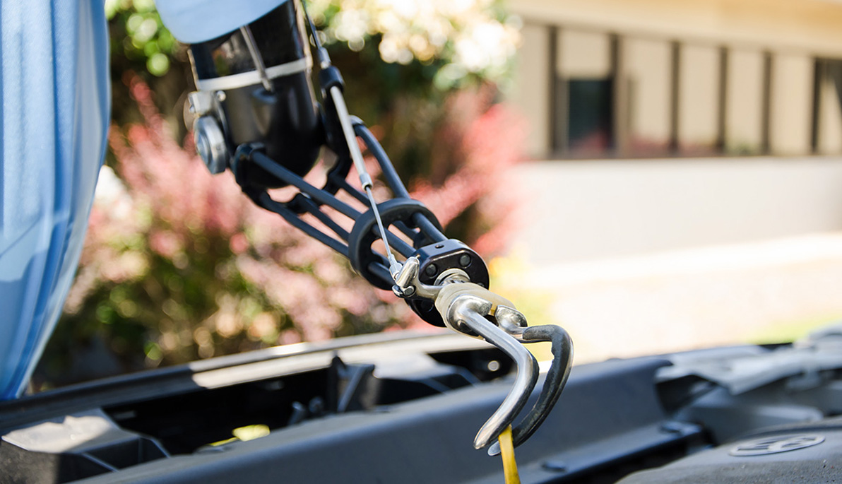 Person with prosthetic arm working on car