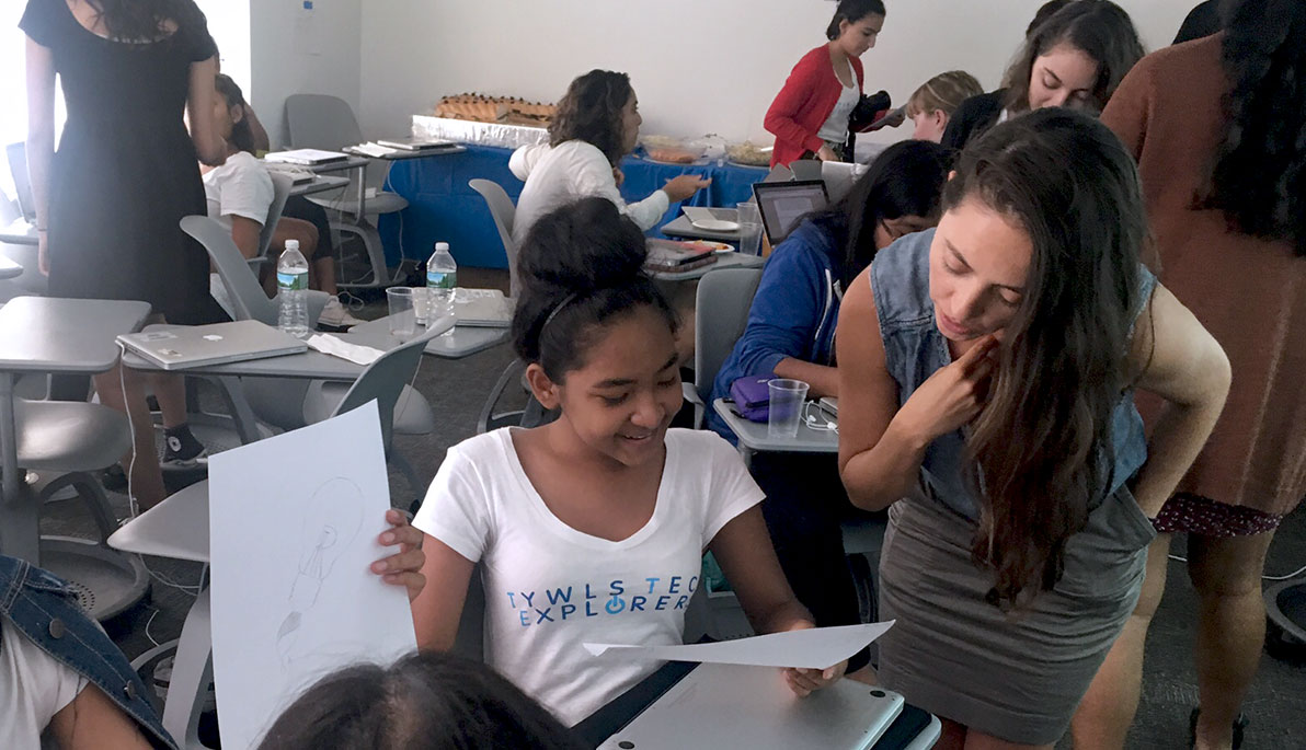 Andrea Chaves (M.S. ’12) with Tech Explorers students in an NYIT classroom.