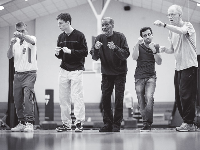 Boxers start each class warming up with volunteers and instructors in a circle.