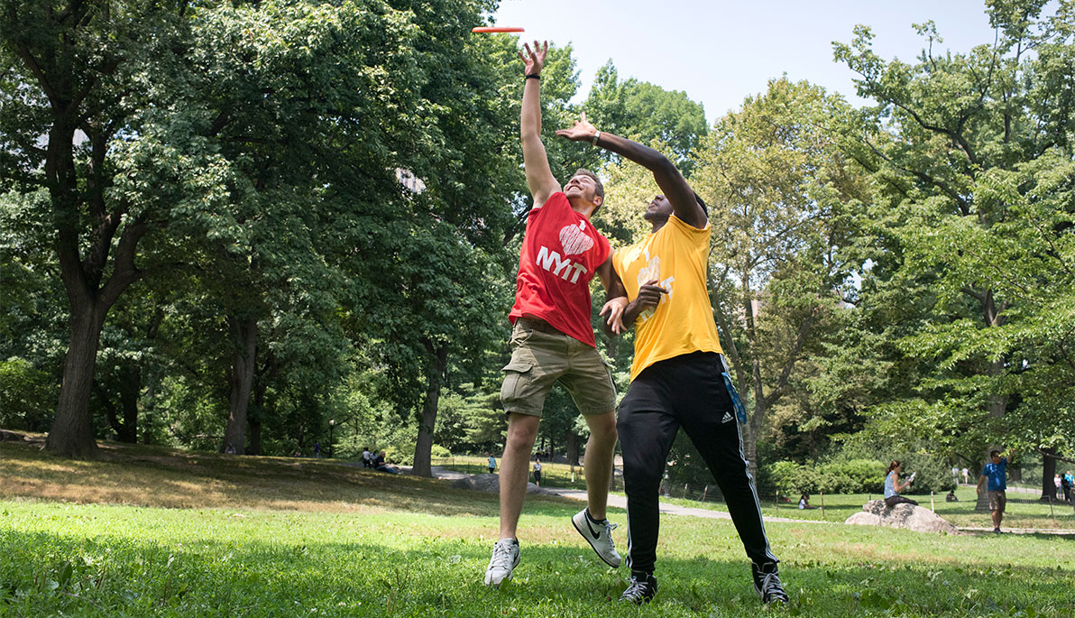 NYIT students playing frisbee NYIT students playing frisbee