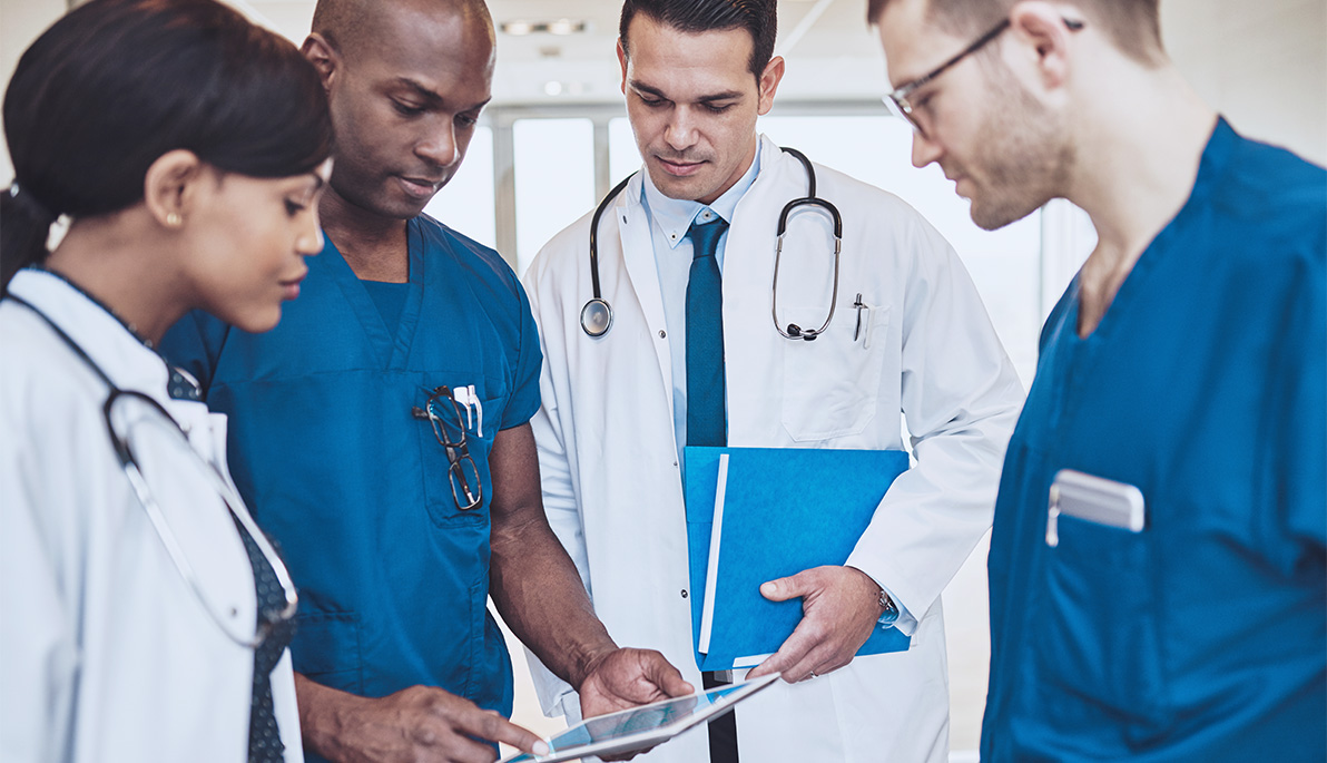 Doctors and nurses looking at a chart. Doctors and nurses looking at a chart.