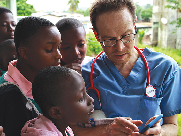 Faculty member Michael Gindi shares American culture with Ghanaian school children.