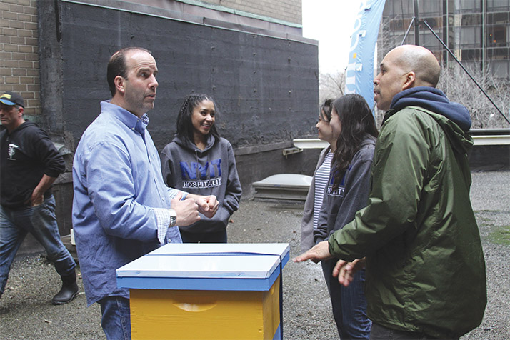 Robert Koenig and hospitality students taking care of the beehives.