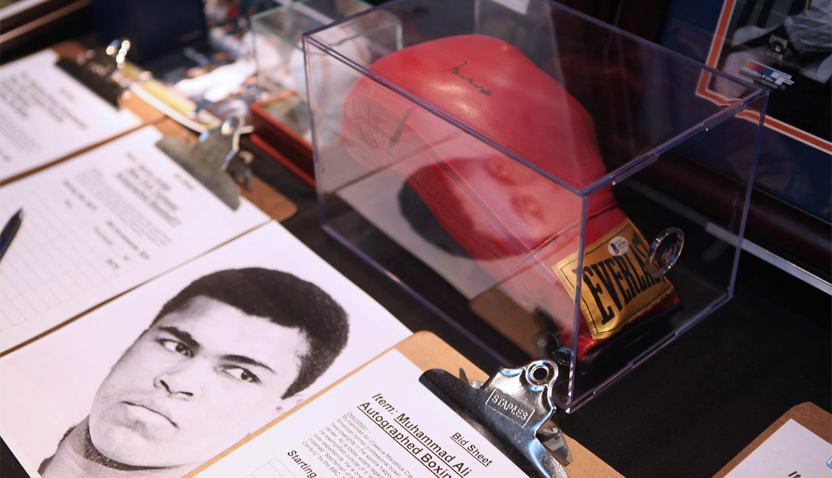 A photo of Muhammad Ali and his boxing gloves.