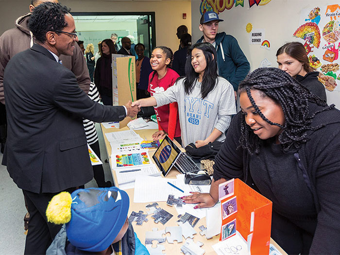 Students greet visitors, including the Rev. Al Taylor