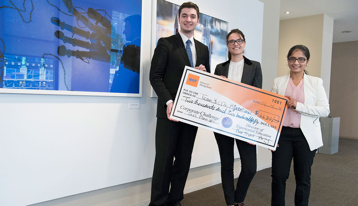 The winning team with their 1st place prize: (left to right) Ajilan Okman, Melanie Benyadi, and Pooja Patel.