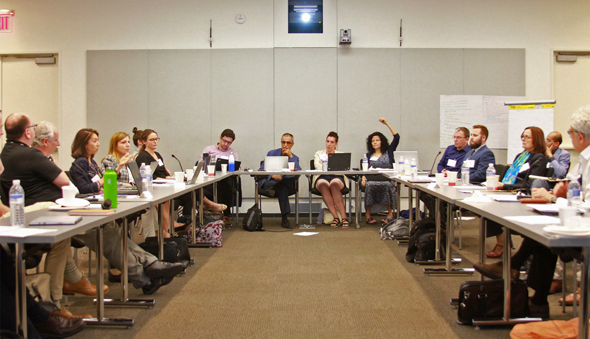 Researchers seated around conference tables