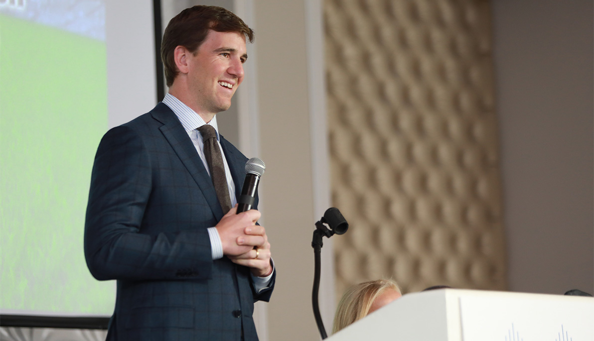 Eli Manning at a podium.