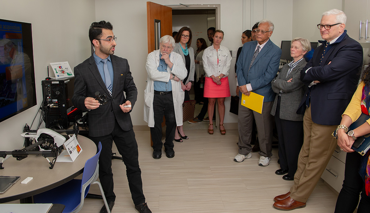 Ehsan Kamel giving a tour of the new facility.