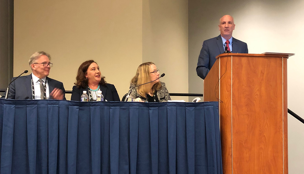 Michael Nizich speaking at a podium at the 2019 NAFSA Annual Conference & Expo