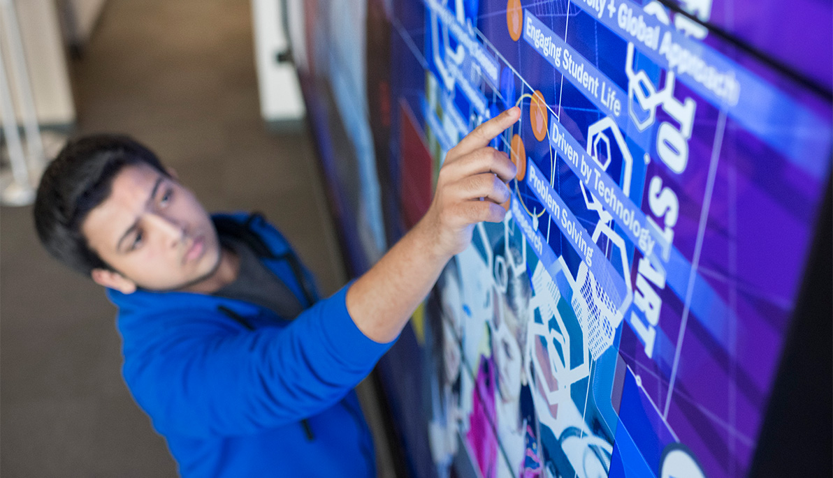 Student pointing at electric board