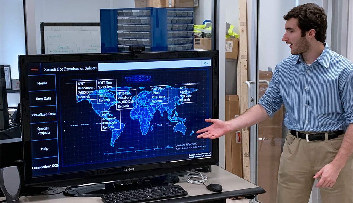 Student in front of a monitor discussing the data displayed an informational world map