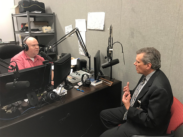 A professor speaking with a radio host