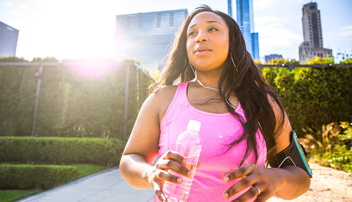 Runner in a city park takes a break for some water.