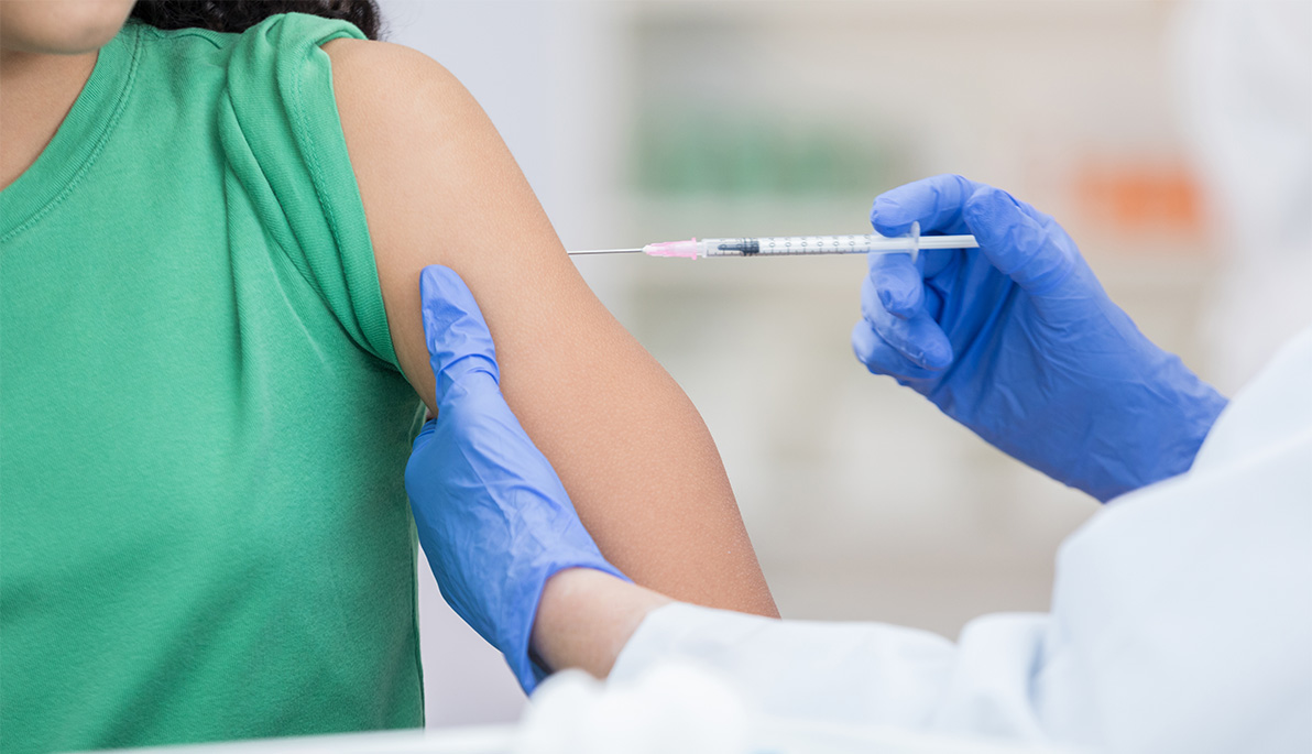 Person receiving a vaccine.