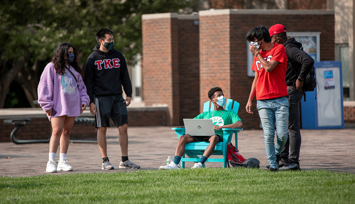 Diverse group of New York Tech students social distancing on the Long Island campus.