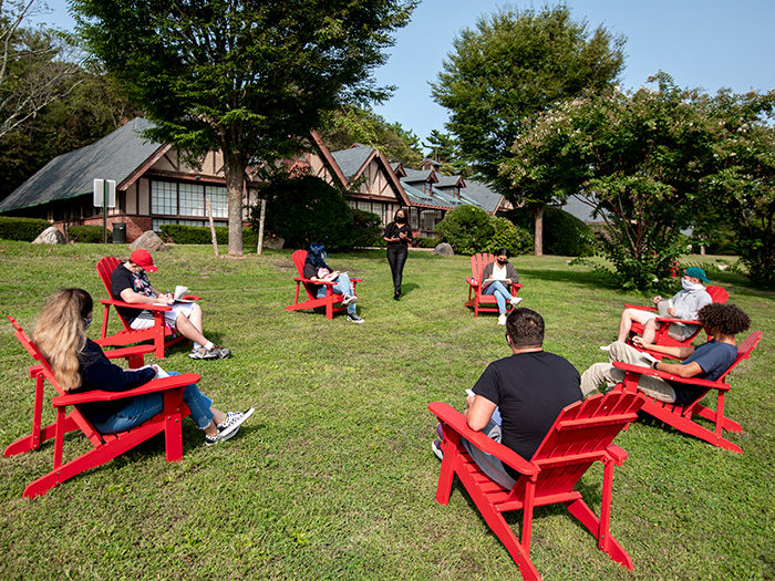 Students and faculty holding class outdoors