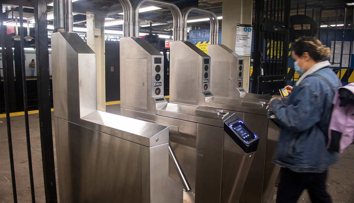 Person going through a New York City subway turnstile.