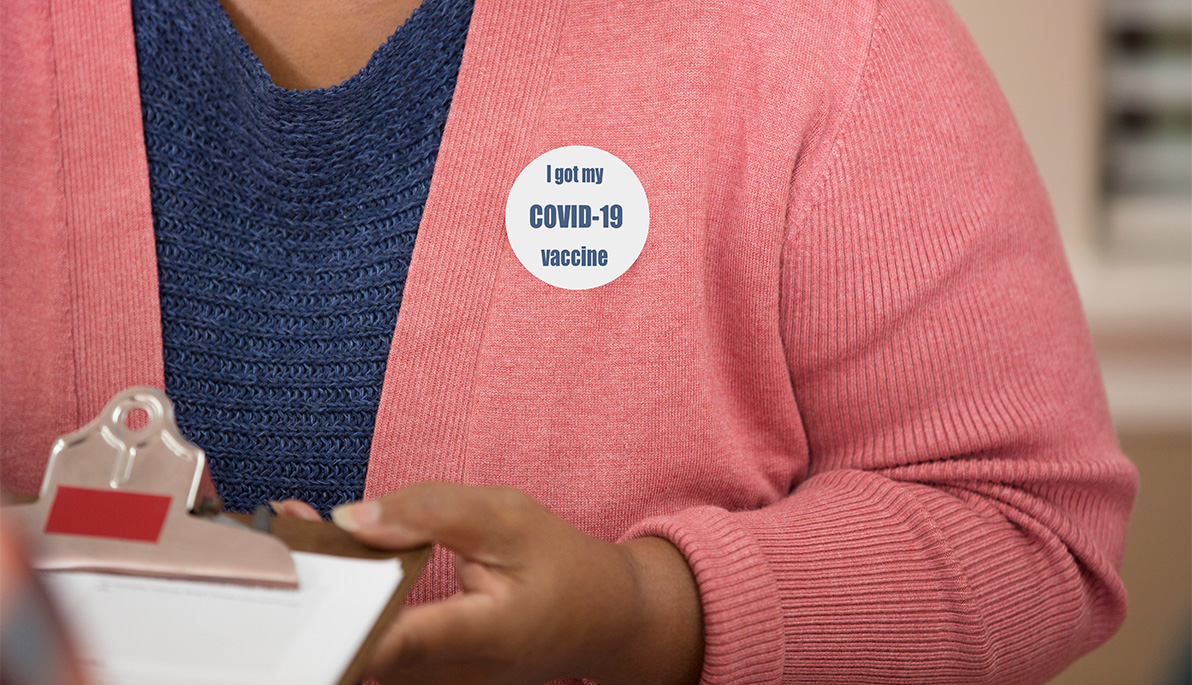 Woman wearing a vaccination sticker