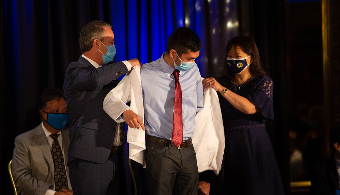 NYITCOM student being coated by his parents.