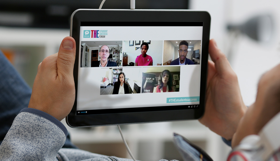 A person watching the panel discussion on a tablet.