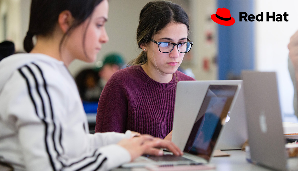 Mashup of Red Hat logo and two people working on laptops