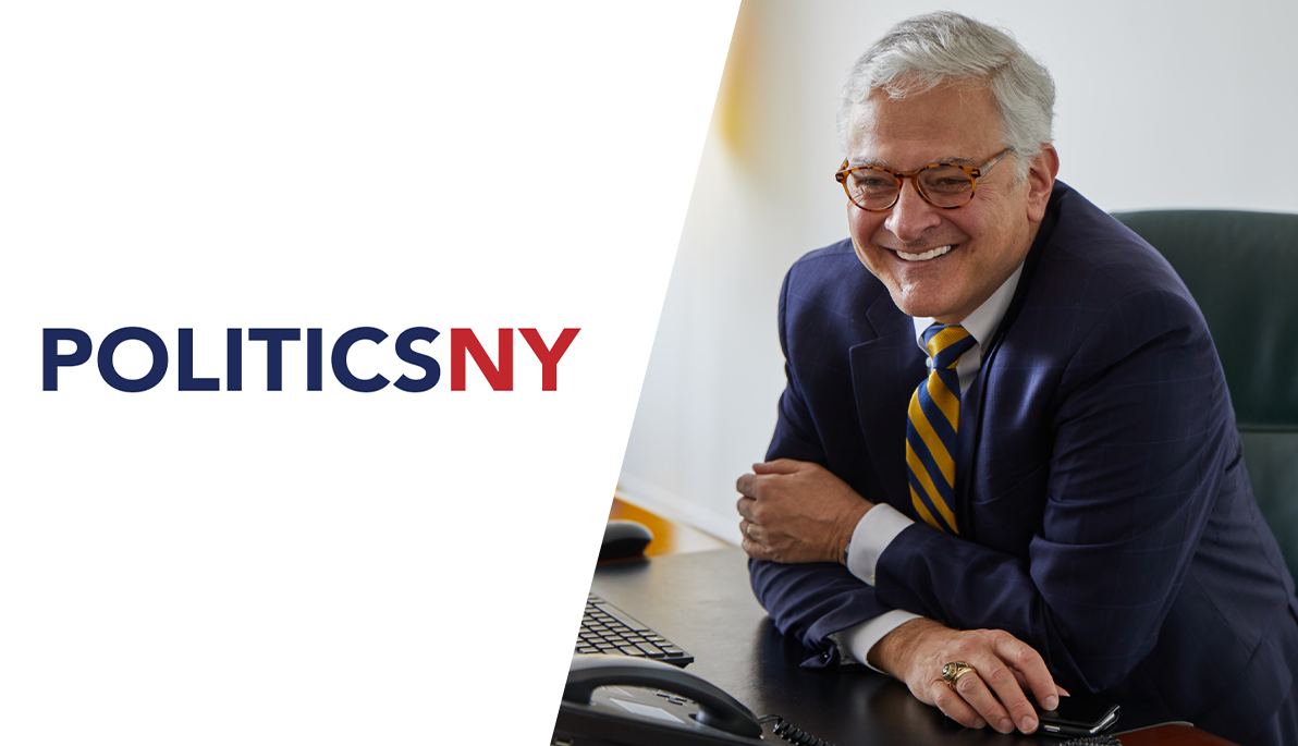 New York Tech President Hank Foley sitting at a desk