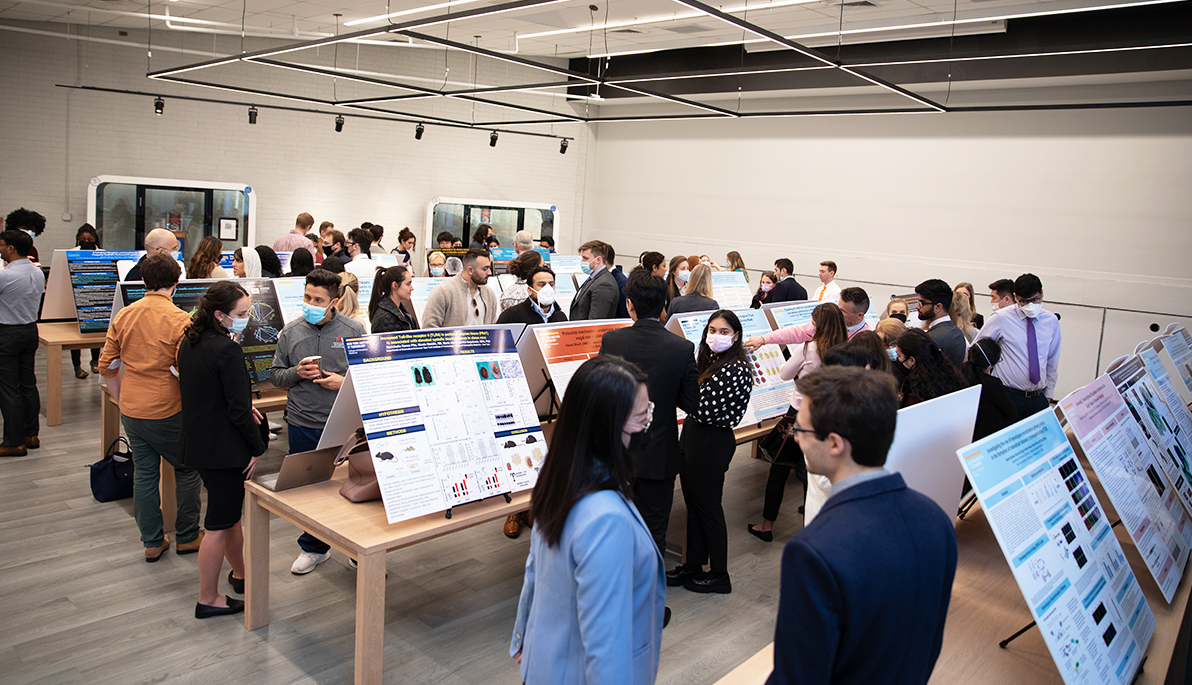 Students presenting work at the NYITCOM Student Research Symposium