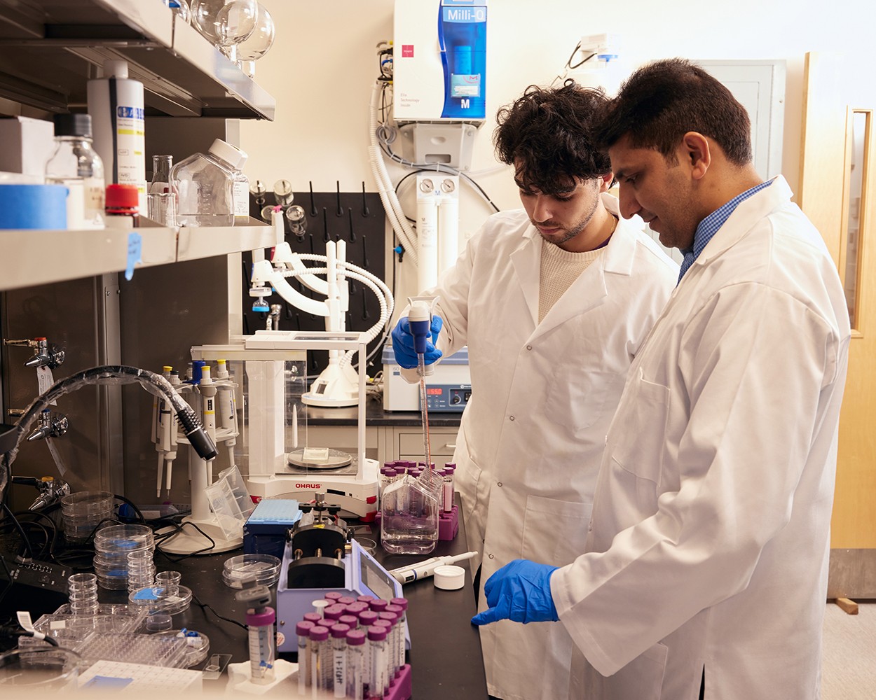 student and faculty working in lab