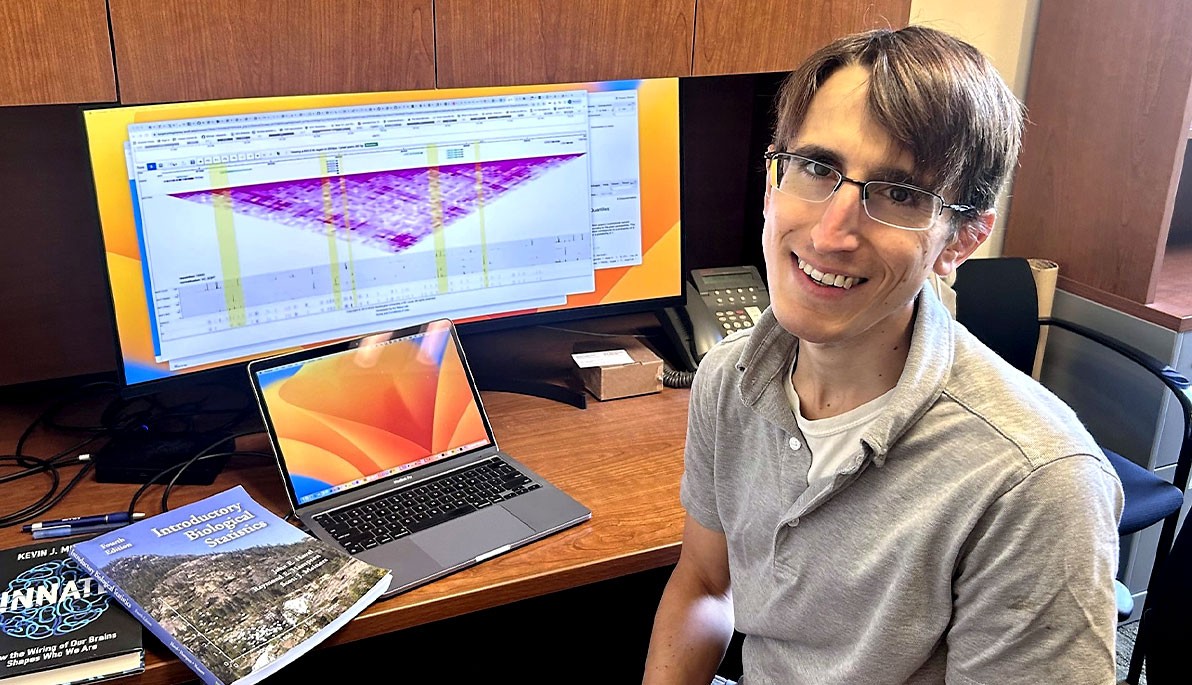 William Letsou sitting at his desk in front of a computer