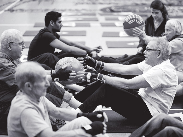 Boxers move between stations doing various activities such as core strengthening and circuit-training exercises.