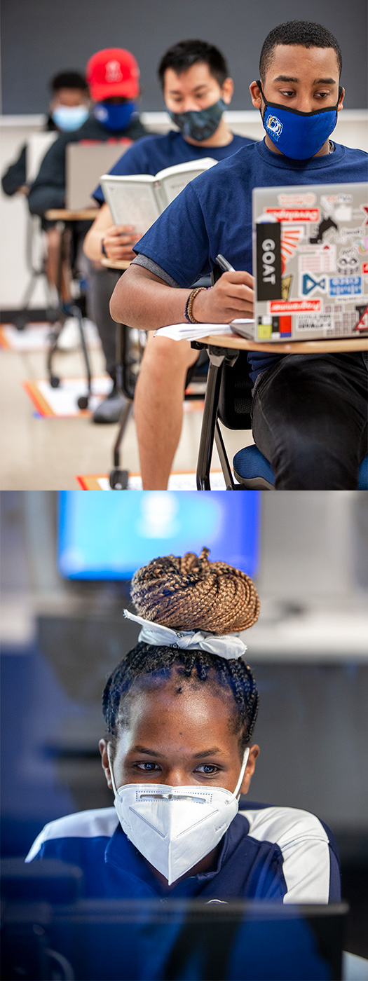 Masked students work at desks in classroom