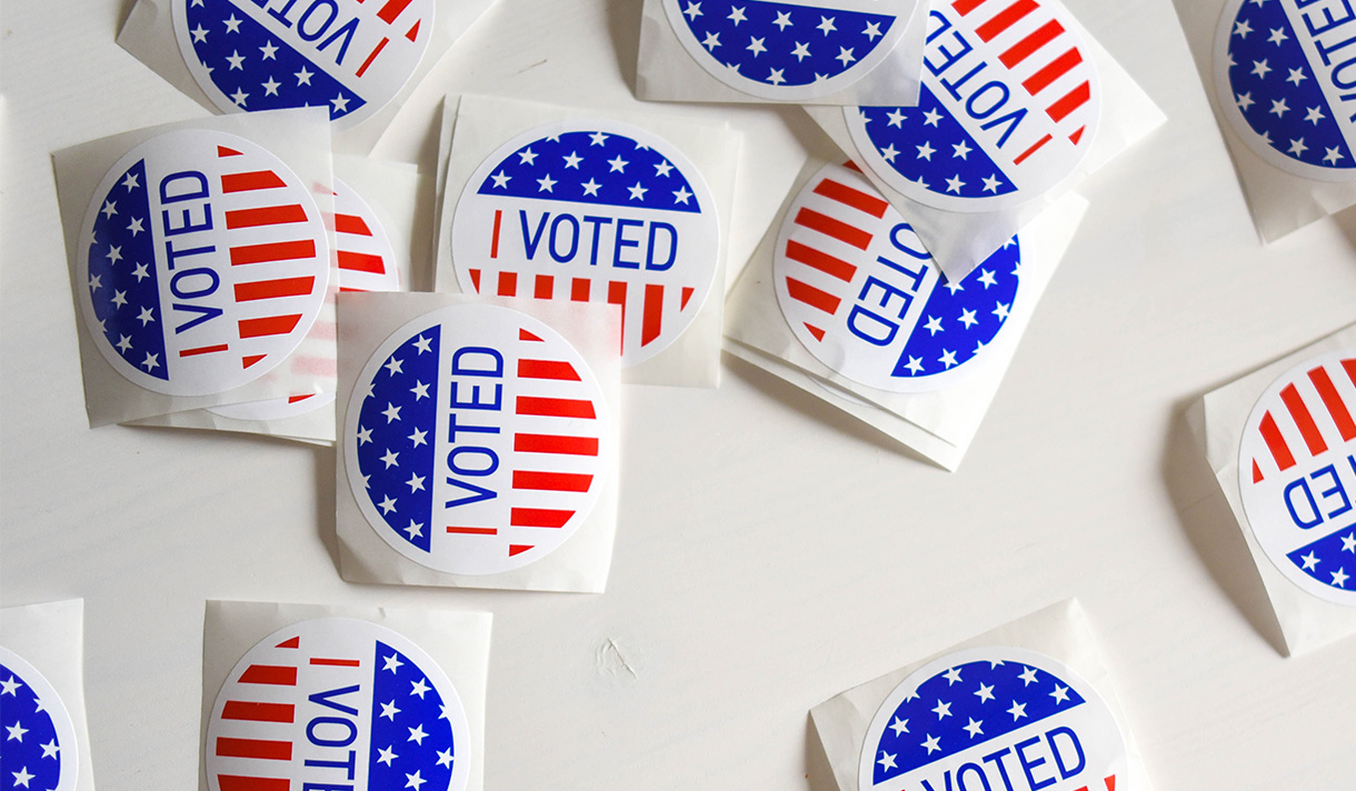 Stickers that say "I voted" scattered on a table