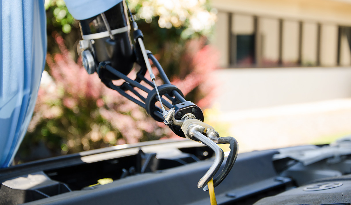 Person with prosthetic arm working on car