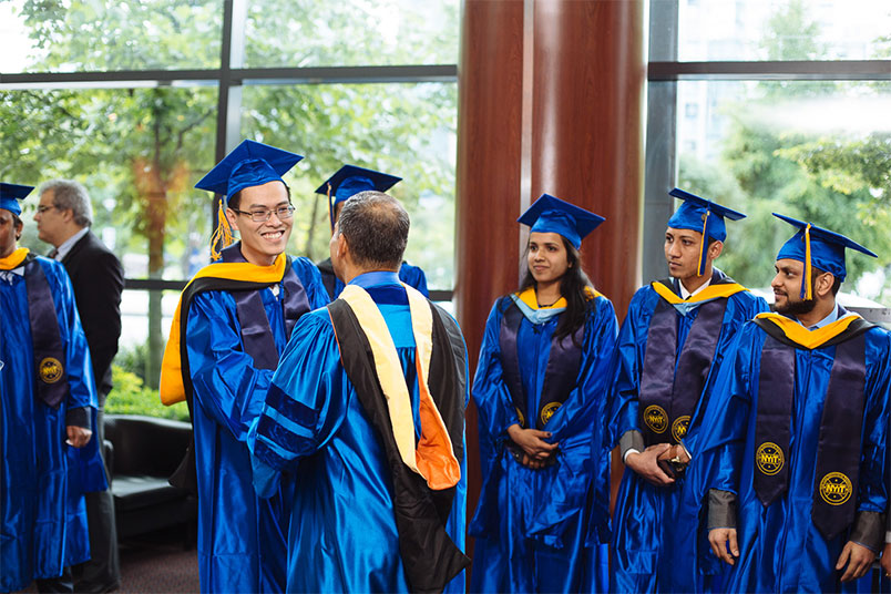 Vinh Luc Tran (smiling, left) was the 2016 graduate speaker. He also received an academic achievement award.