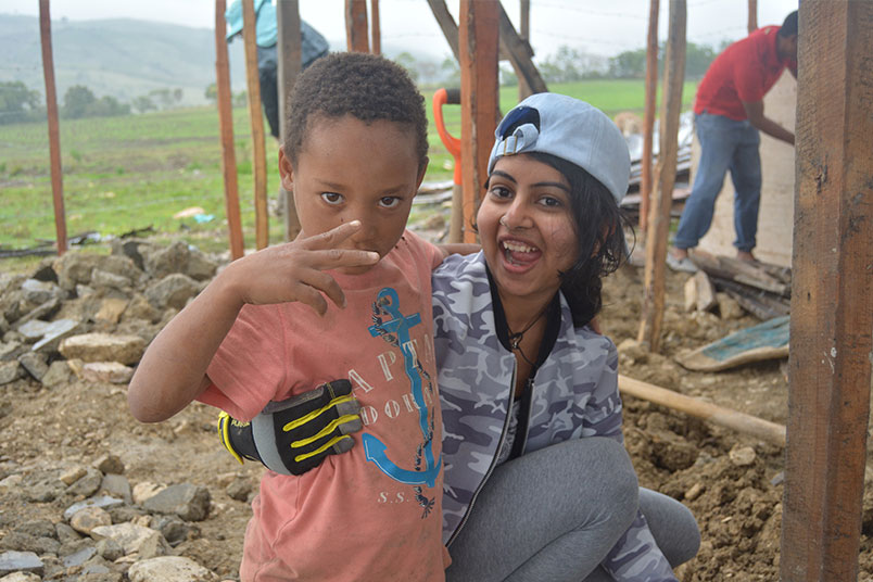 NYIT student Hinali Shah with one of the local children.