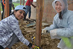 From left: NYIT students Hinali Shah and Yan Xu installing barbed wire.