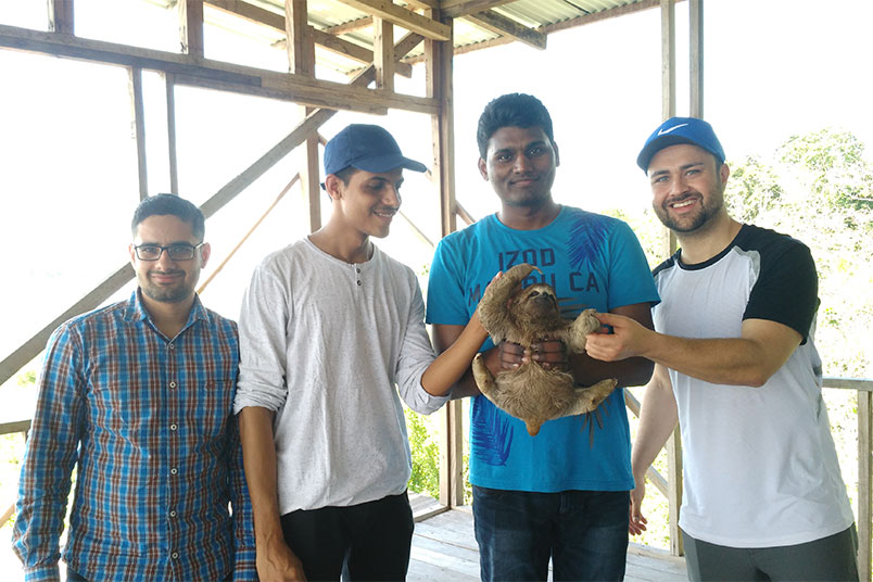 The students pose with a baby sloth. Photo by Patrick Quio Valdivia