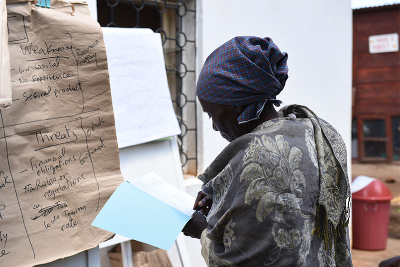 Rita, one of the women in the course, takes notes.