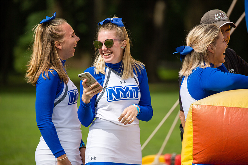 NYIT cheerleaders wait in line to play lawn games.