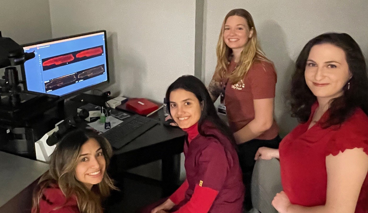 Students in front of SOURCE poster presentation