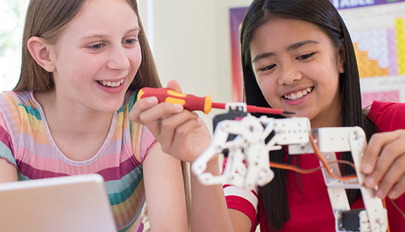 Two kids working on robot